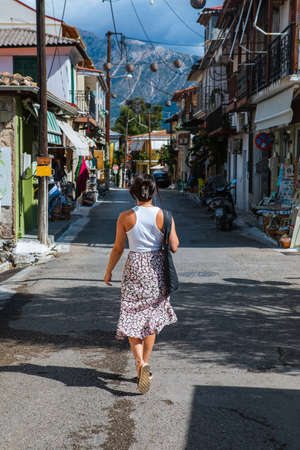 woman traveler walking by Vasiliki town street Greece Lefkadaの写真素材