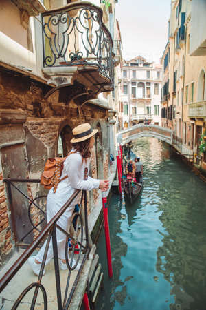 portrait of smiling woman looking at canal with gandolaの写真素材
