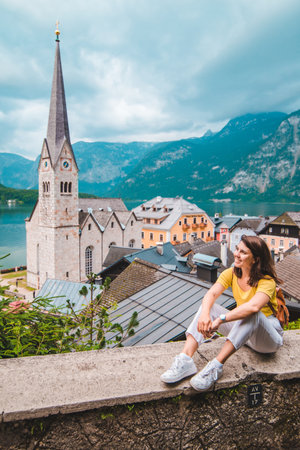 woman sitting and enjoying the vie of hallstatt austria