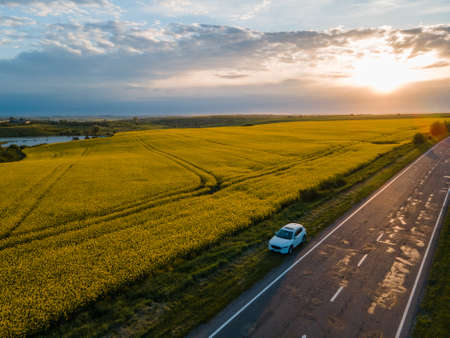 car parked at roadside of speedway sunset on backgroundの写真素材