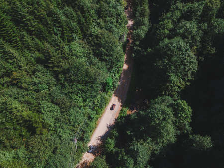 aerial view of quad bike riders at mountain trail road copy spaceの写真素材