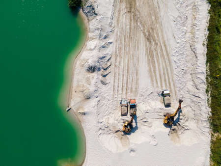 heavy industry overhead view of excavator at sand quarry summer sunny dayの写真素材
