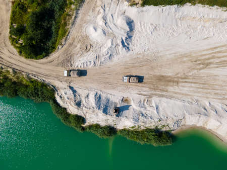heavy industry overhead view of excavator at sand quarry summer sunny dayの写真素材