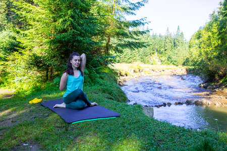 woman do yoga at river beach