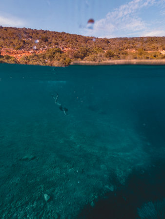 sexy woman swimming underwater in diving mask with flippers summer vacationの写真素材
