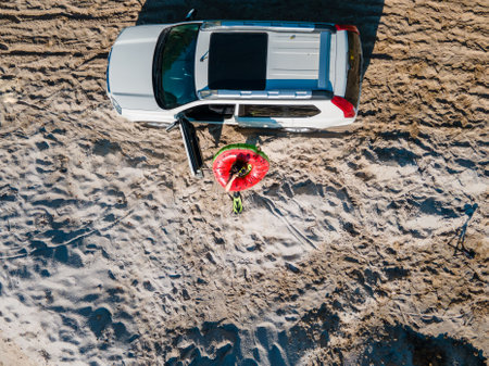 overhead top view happy woman getting out from the car in flippers with inflatable ring and bag copy...