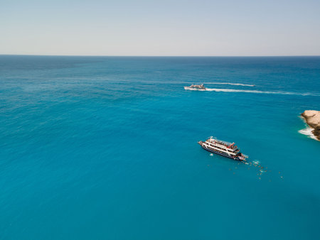 aerial view of porto katsiki beach with cruise boat people having fun swimming jumping Greece summer vacationの写真素材