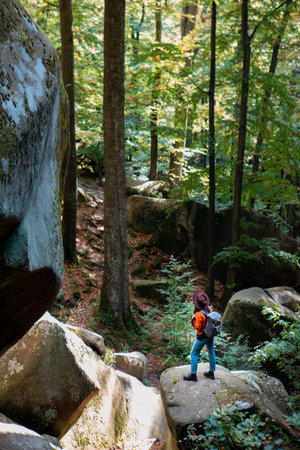 woman traveler with backpack walking by trail in canyonの写真素材