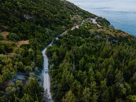 overhead view of car moving by road next to sea shoreの写真素材