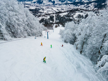 aerial view of snowboarders free riders at ski slopeの写真素材