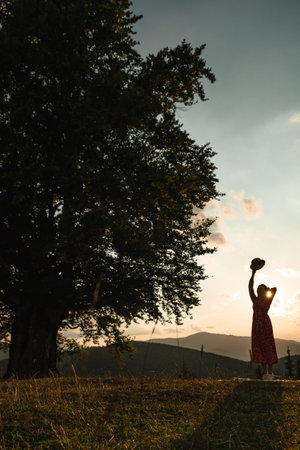 woman near old big beech tree in the mountainsの写真素材