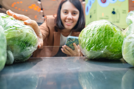 Woman looking for vegetable Taking Products From Shelf Couple Customers Shopping With Checklist