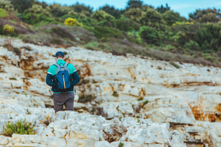 man climbing by rocky hill. travel conceptの写真素材