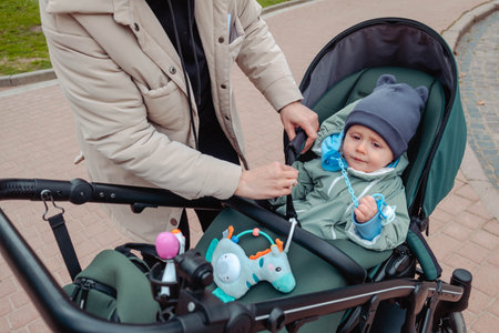 mother to fasten her son with seat belts