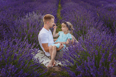 father and daughter are playing in a lavender fieldの写真素材