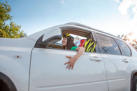 sea car travel trip smiling woman driver in car full of vacation stuff