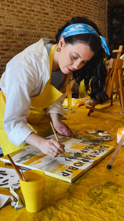 Woman with brush painting on canvas