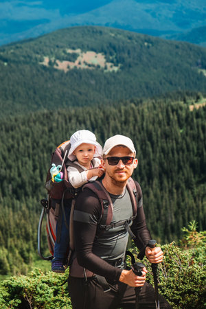 A man with a baby on the mountainの写真素材