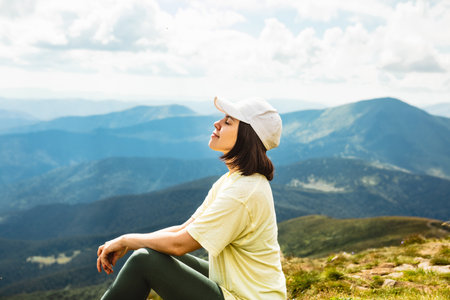 Woman on the top of a mountainの写真素材