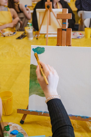 woman hand holding brush paint on canvasの写真素材