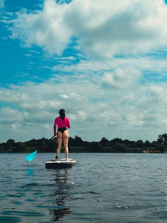 beautiful woman standing on supboard keep balanceの写真素材