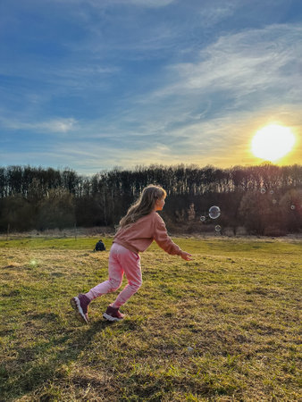 happy toddler girl run by fieldの写真素材