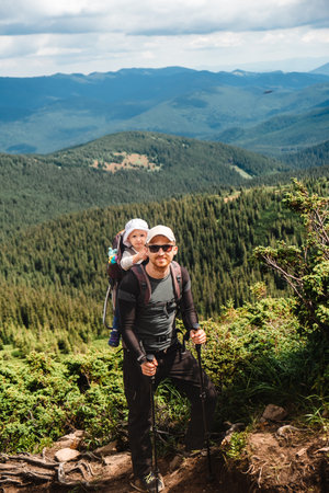 A man with a baby on the mountain