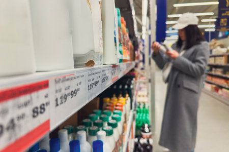 woman in groceries store choosing shampooの写真素材