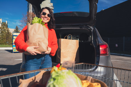 woman put packages in car trunk