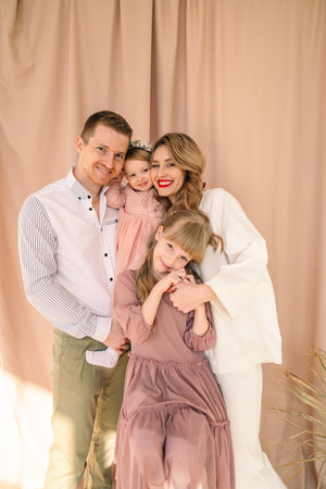 happy family of four father with mother and two daughtersの写真素材