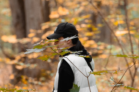 woman with basket looking for mushrooms in autumn forest