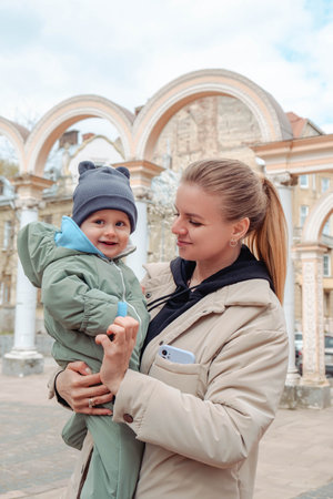 Happy mom holds baby in her arms