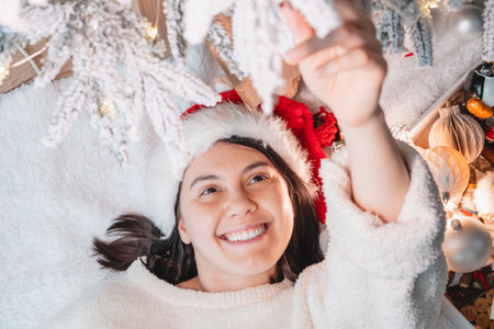 happy woman taking selfie near christmas treeの写真素材
