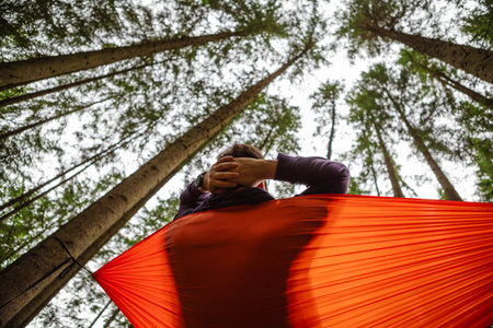 happy man in hammock in the middle of the forestの写真素材