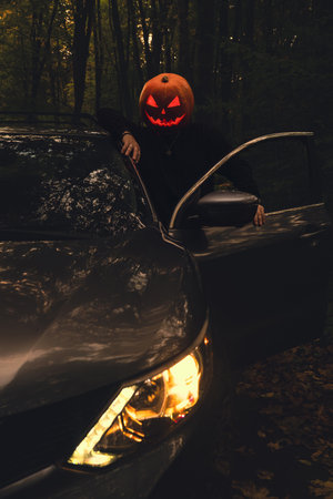 halloween concept man with pumpkin head in suv car