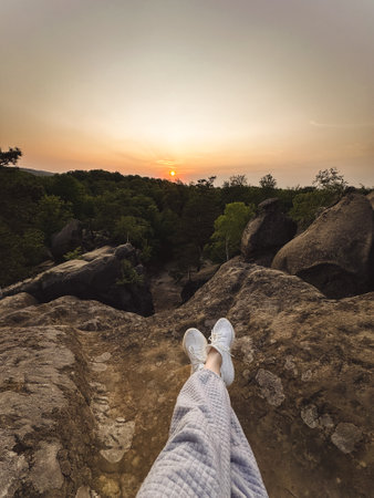 happy woman enjoying sunset above carpathian mountainsの写真素材
