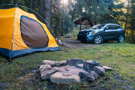 Camping Scene with SUV and Yellow Tentの写真素材