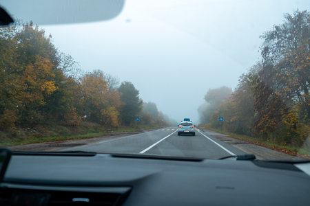 Foggy Autumn Drive on a Country Roadの写真素材