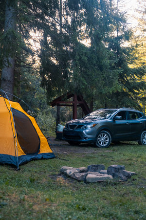 Camping Scene with SUV and Yellow Tentの写真素材
