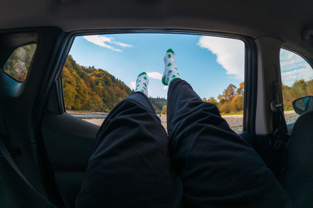 Relaxing in a Car with Legs Out the Windowの写真素材