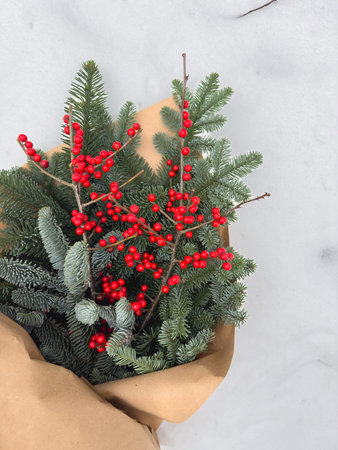 Evergreen and Red Berry Bouquet on Snowの写真素材