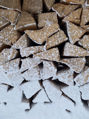 Snow-Covered Firewood Stack in Winter