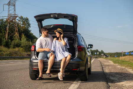 Couple Enjoying a Sunny Day by the Carの写真素材