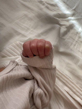 Close-Up of Babys Hand in Ribbed Sleeve
