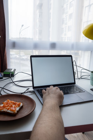 Minimalist Workspace with Laptop and Breakfastの写真素材
