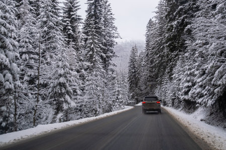Car on Snowy Mountain Road