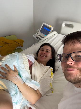 Happy Family with Newborn in Hospital Roomの写真素材