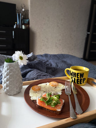 Cozy Breakfast with Salmon and Eggs in Bedの写真素材