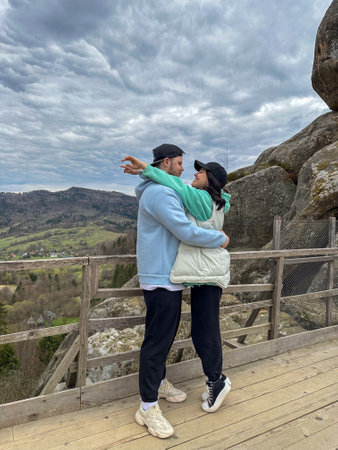 Couple Embracing with Scenic Mountain Viewの写真素材