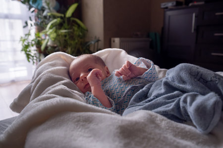 Newborn Baby Resting in Cozy Home Environmentの写真素材
